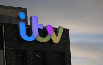 SALFORD, ENGLAND - JANUARY 05:  The ITV logo is displayed on studio buildings studios at Media City in Salford Quays which is home to the BBC, ITV television studios and also houses many media production companies on January 5, 2015 in Salford, England. The BBC and neighbour ITV Granada with its cobbled street studios of ITV soap opera 'Coronation Street', line the banks of the Manchester Ship Canal.  (Photo by Christopher Furlong/Getty Images)